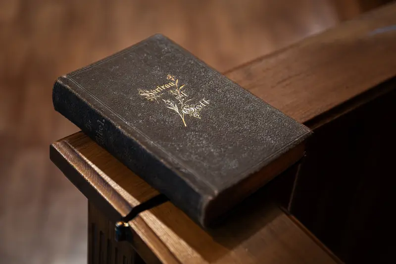 Vintage Book with Golden Emblem on Wooden Surface