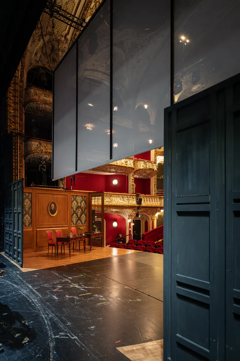 Backstage View of Volkstheater's Ornate Interior Through Open Door