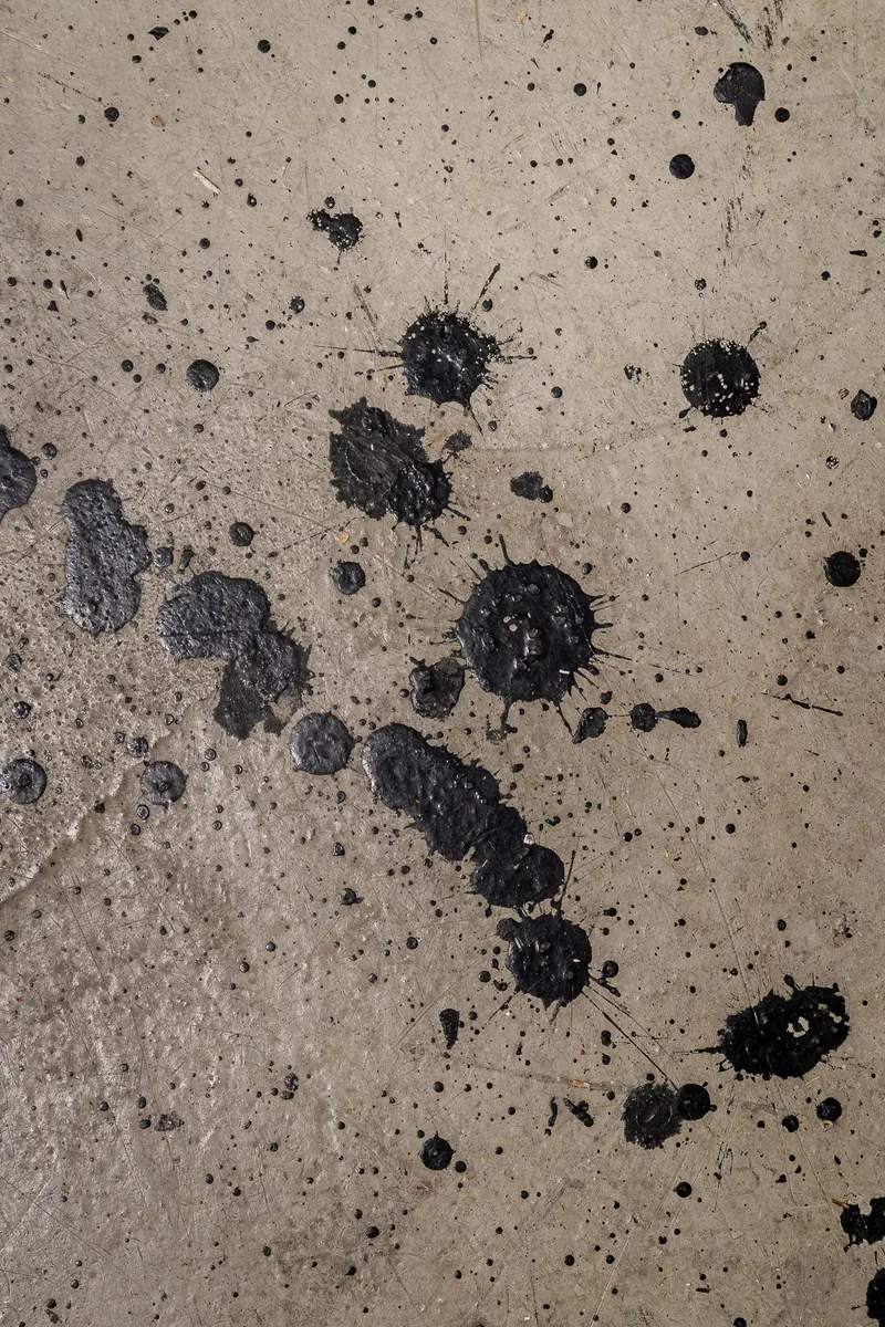 Black Paint Splatter Marks on Concrete Surface Texture