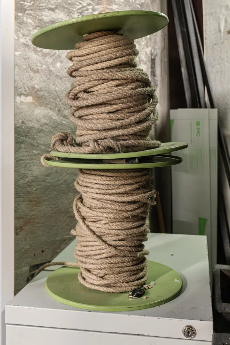 Nautical Rope Coiled on Green Spindles in Storage Area