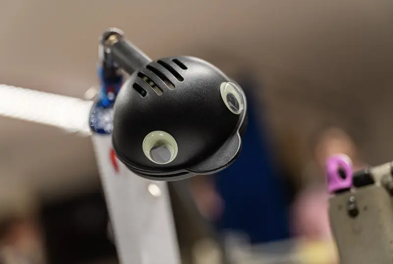 Black Robotic Microphone Positioned on Performance Stage Lighting Rig