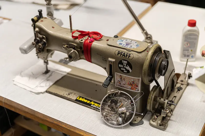 Vintage Pfaff Sewing Machine with Red Ribbon at Workstation