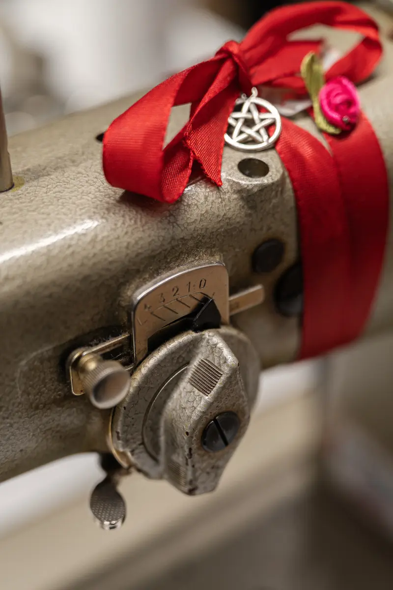 Vintage Sewing Machine with Red Ribbon and Pentagram Charm