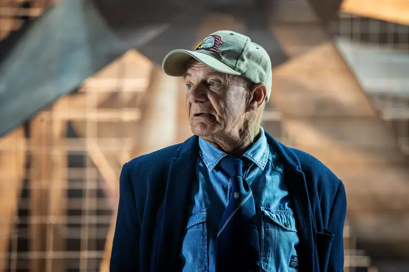 Veteran in Blue Denim and Baseball Cap at Theatrical Production