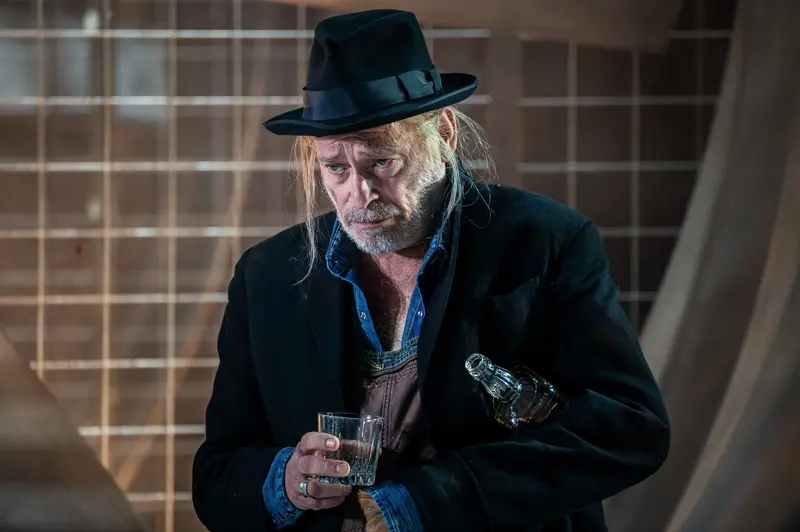 Contemplative Actor in Theatrical Costume during "Von Mäusen und Menschen" Production