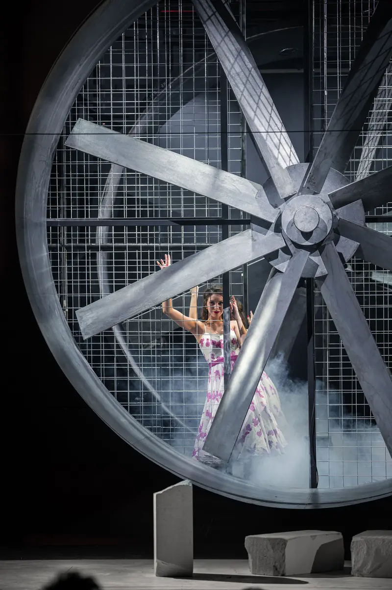 Performer in Large Industrial Wheel During "Von Mäusen und Menschen" Theater Production