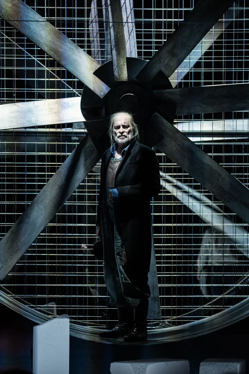Dramatic Figure Positioned Within Industrial Large-Scale Fan Structure