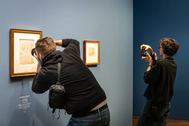Visitors Closely Examining Artworks at Leonardo Dürer Exhibition, Albertina Museum