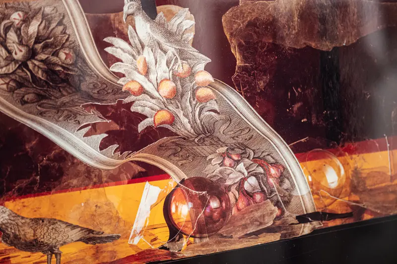 Ornate Glass Artwork with Botanical Motifs and Amber Tones