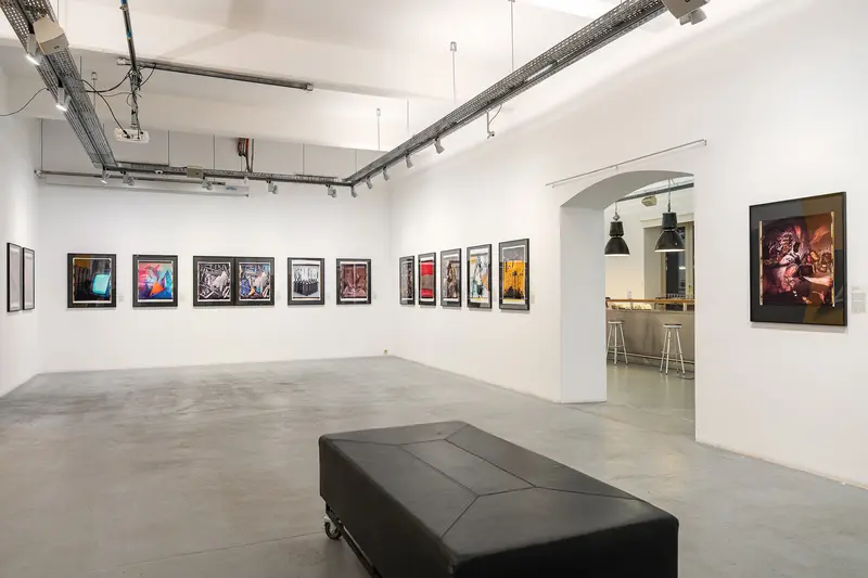 Contemporary Art Gallery Interior with Black Leather Bench and Framed Artworks