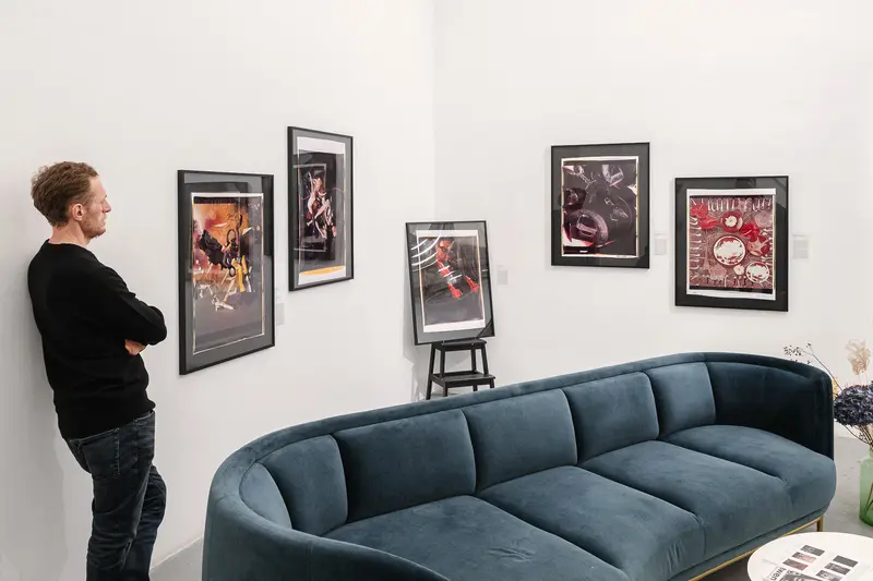 Gallery Interior with Art Prints and Modern Blue Curved Sofa