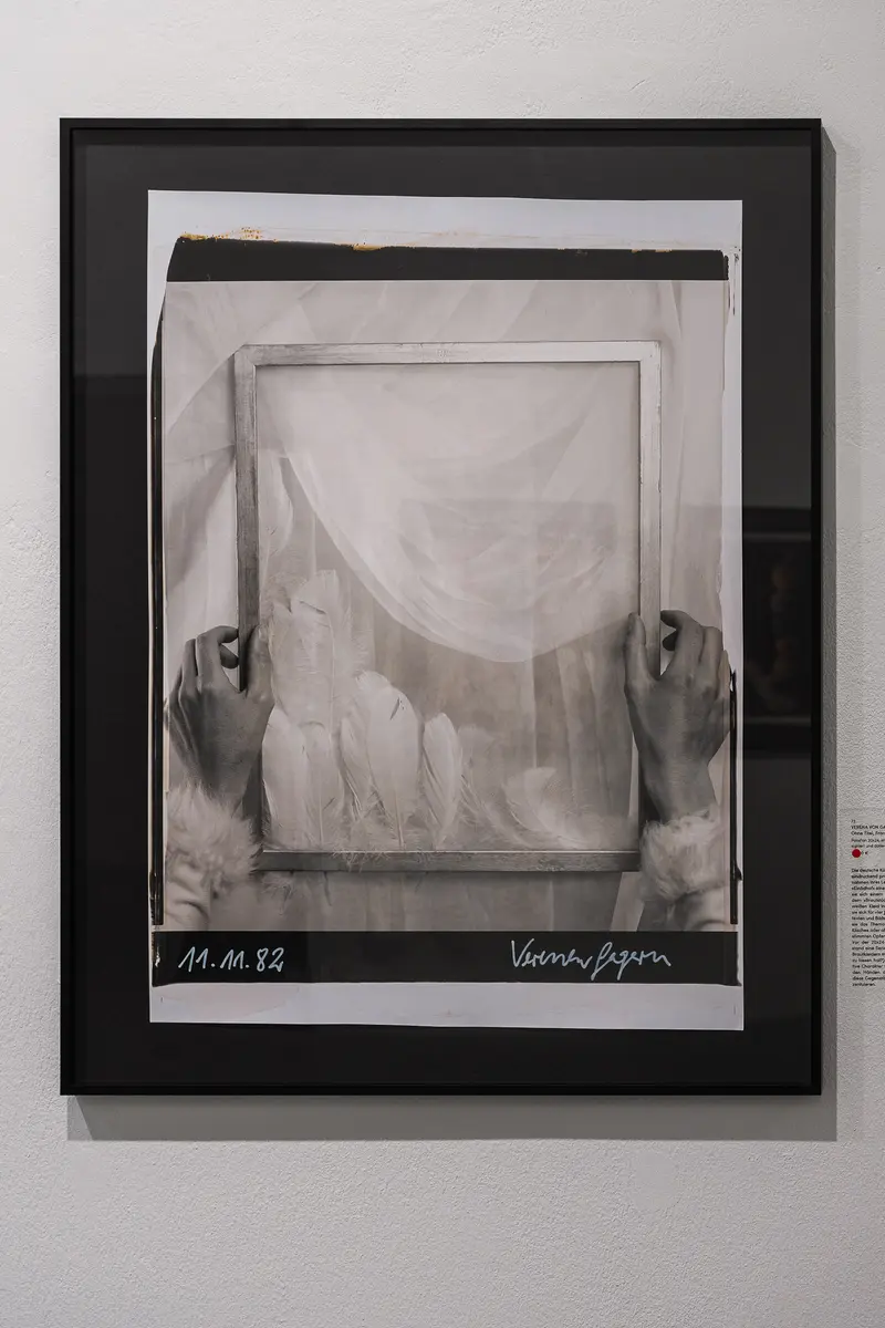 Framed Hands Revealing Draped Fabric in Black and White Photographic Study