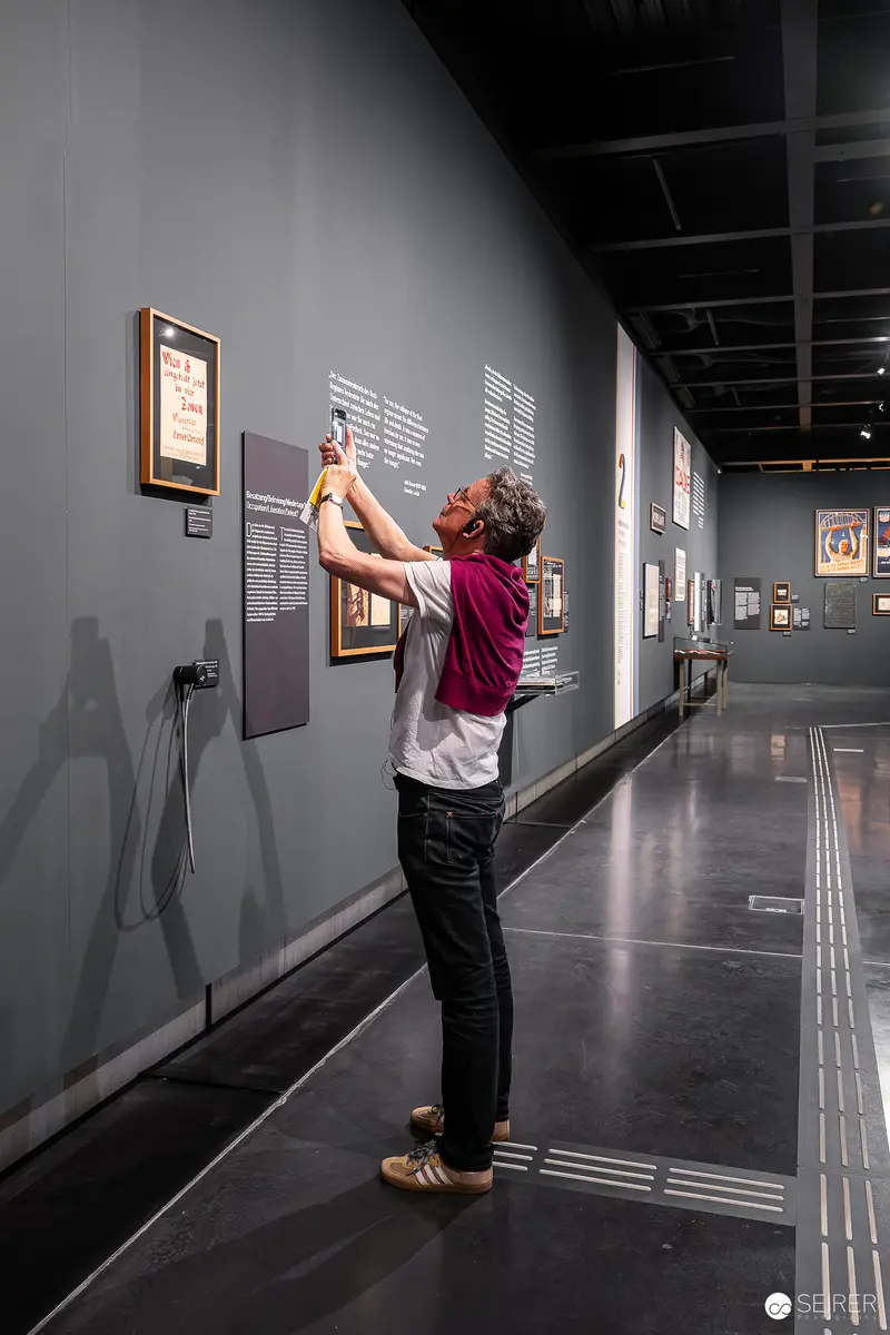 Visitor Examining Exhibition Artwork at Wien Museum's "Controlled Freedom" Display