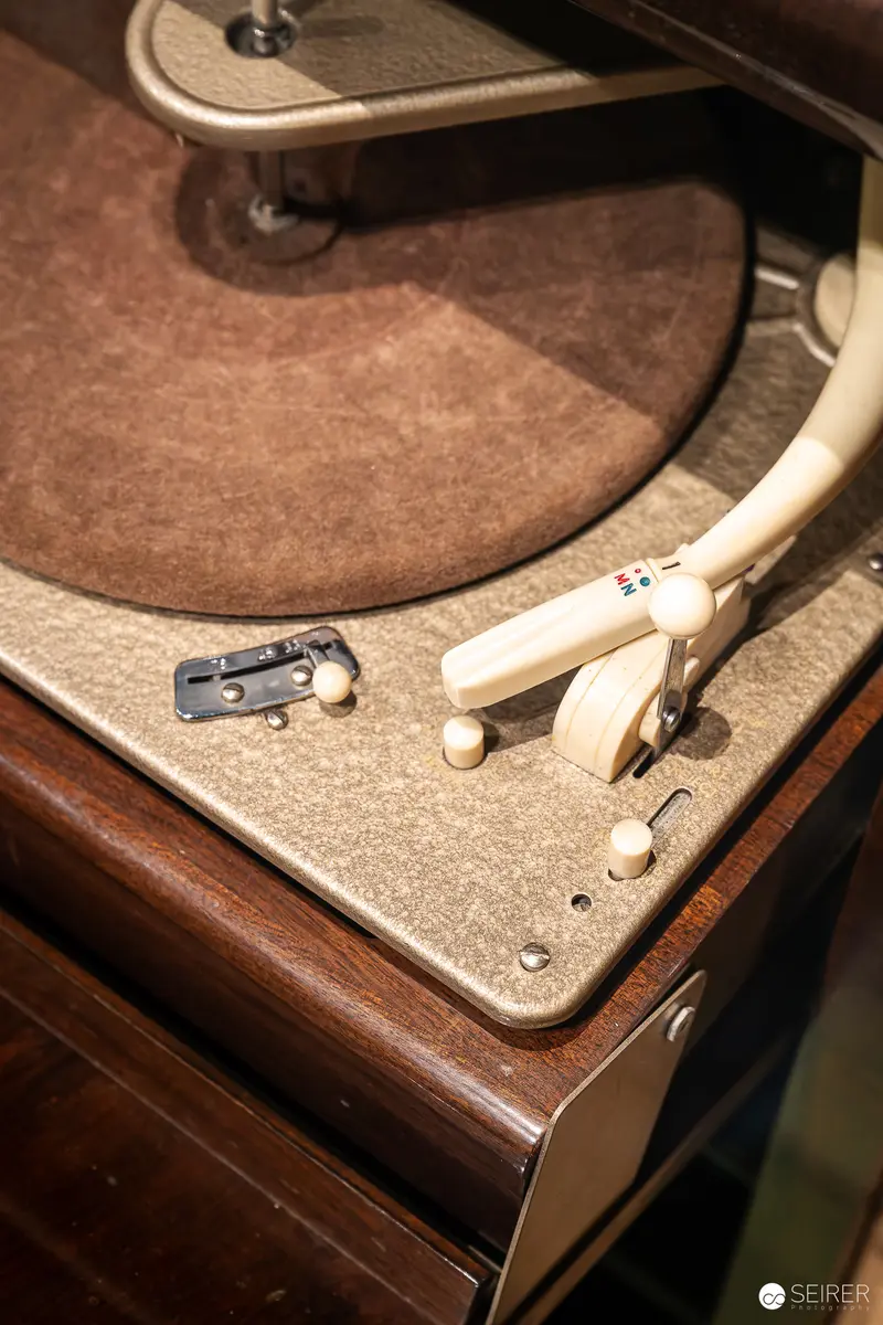 Vintage Turntable with Tonearm on Wooden Record Player Console