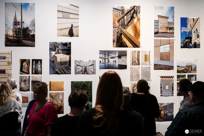 Exhibition Visitors Examine Architectural Photographs at Wien Museum Display