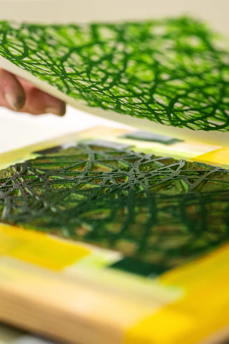 Green Botanical Printmaking Technique Demonstrating Intricate Leaf Overlay
