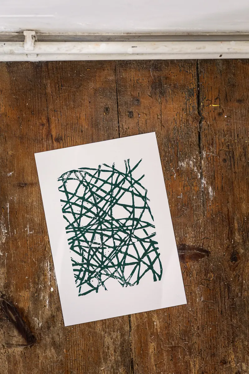 Abstract Green Line Drawing on Vintage Wooden Surface at Famiglia Vienna Exhibition