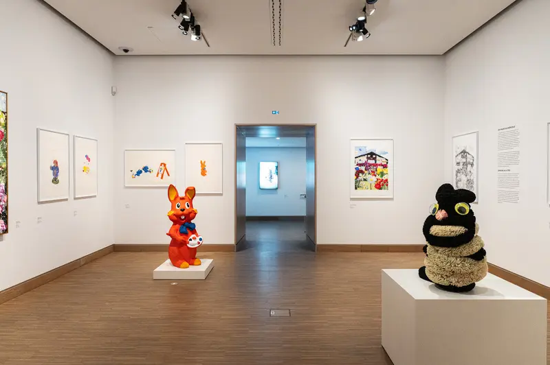 Modern Art Gallery Exhibition with Cartoon Character Sculptures