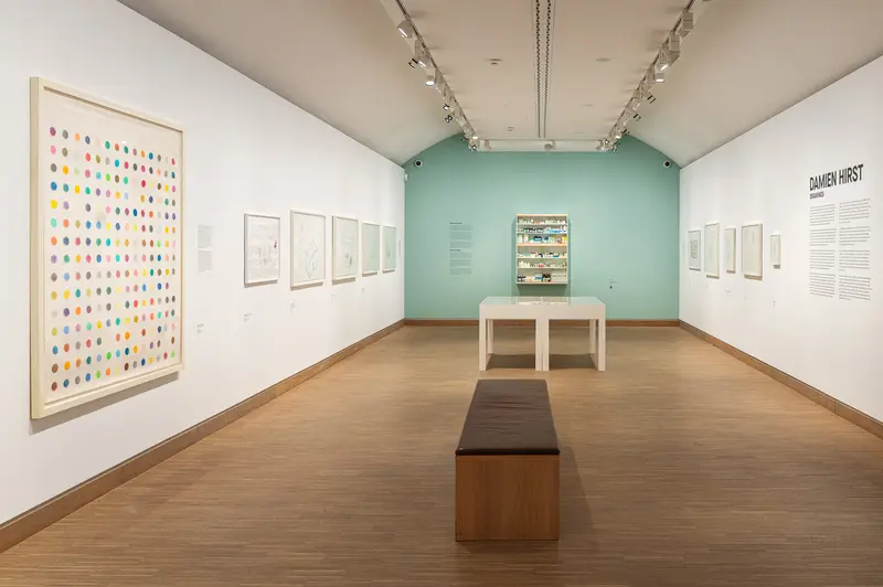 Damien Hirst Gallery Exhibition with Colorful Spot Painting and Display Case