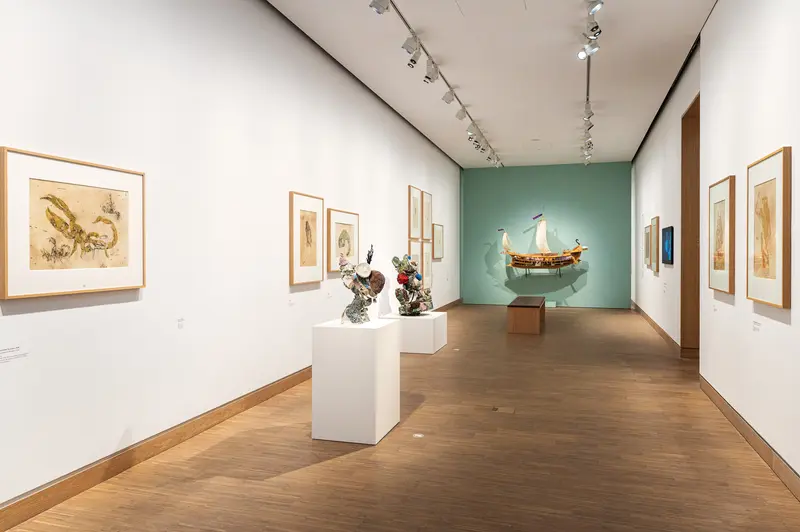 Art Gallery Exhibition with Maritime Model, Sculptures, and Framed Artworks