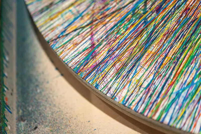 Vibrant Multicolored Linear Artwork with Curved Edge and Textured Background