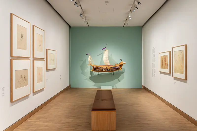 Wooden Ship Model Displayed in Minimalist Museum Gallery Setting