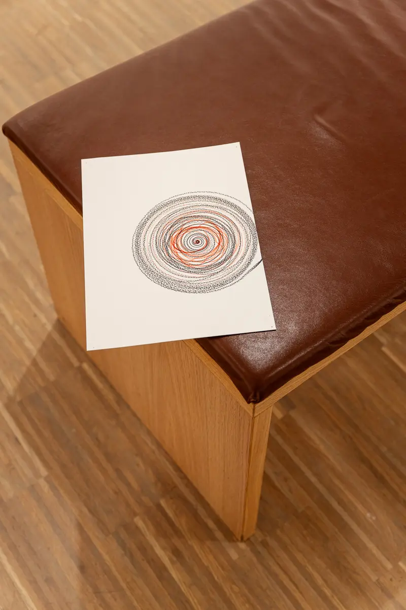 Concentric Circles Sketch on Leather-Topped Wooden Surface