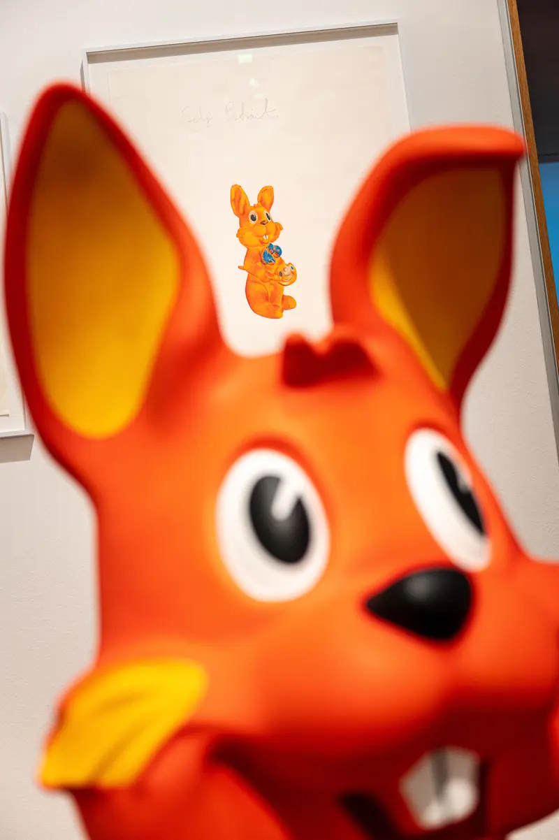Bright Orange Toy Character with Cartoon Bunny Mascot