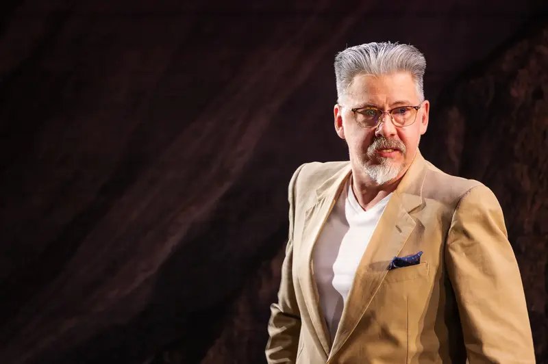 Distinguished Gentleman in Beige Blazer During Theater Rehearsal