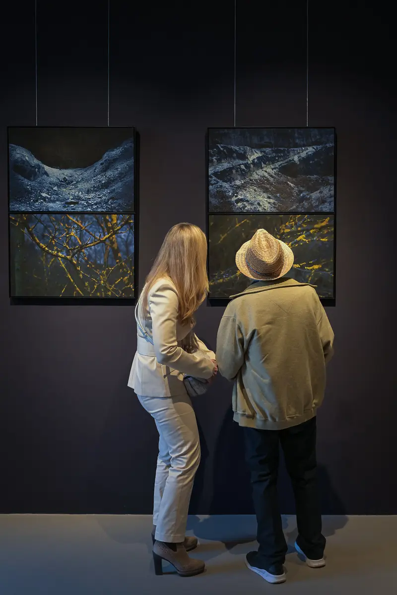G. Herder and K. Feichtinger Viewing Artwork at "Poem of Darkness" Gallery Exhibition