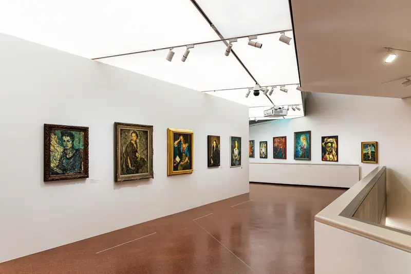 Art Gallery Interior with Modernist Portrait Paintings on White Walls