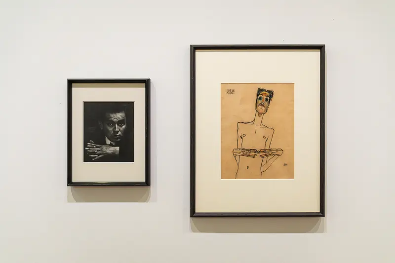 Two Framed Artworks: Expressive Portrait Sketch and Black and White Photography