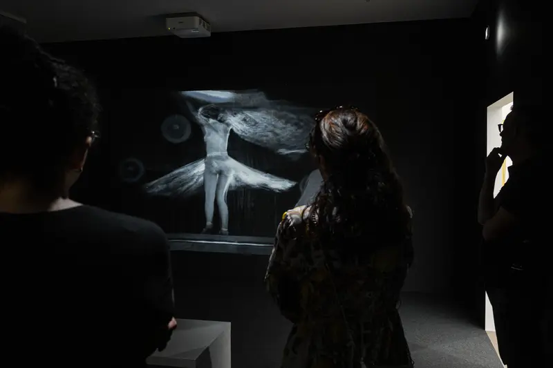 Ethereal Human Figure Projected in Dark Gallery Space During Exhibit