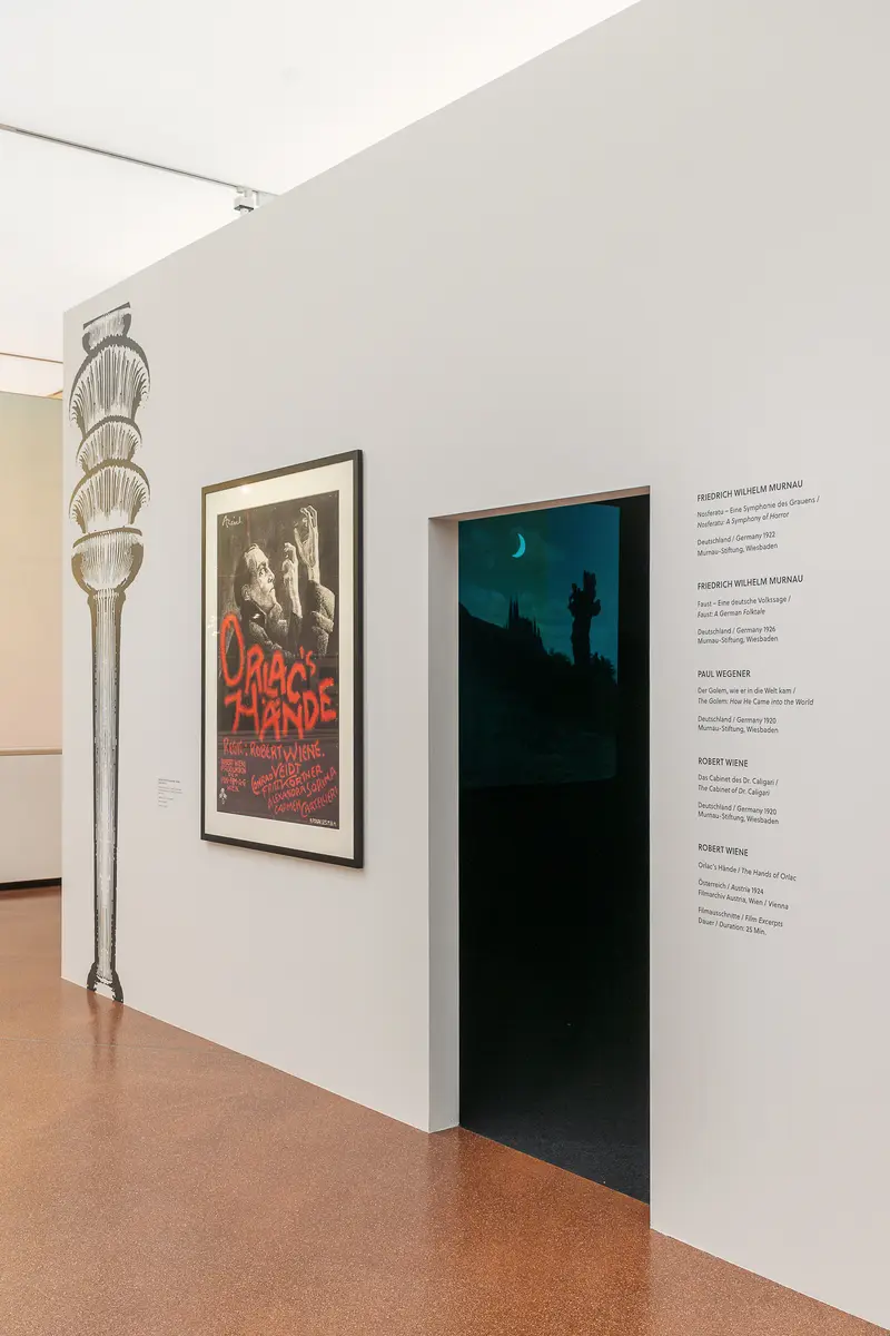 Gallery Exhibition Wall with Vintage Film Poster and Atmospheric Doorway