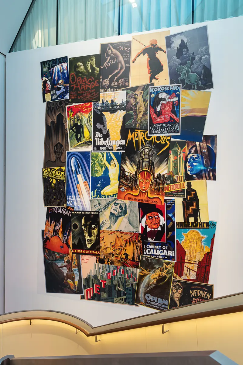 Vintage Cinema and Art Nouveau Poster Collection on Museum Display Wall