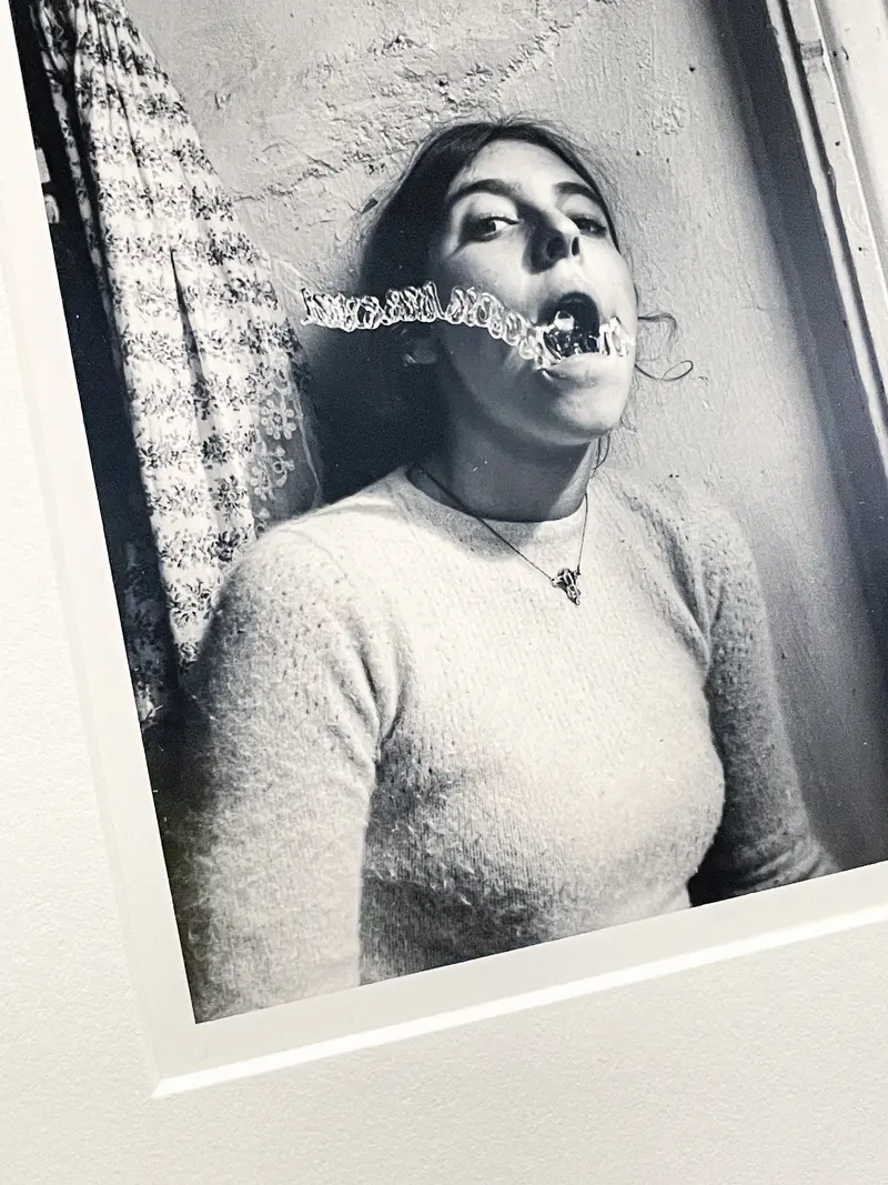 Francesca Woodman's Surreal Self-Portrait with Textured Wall and Blurred Movement
