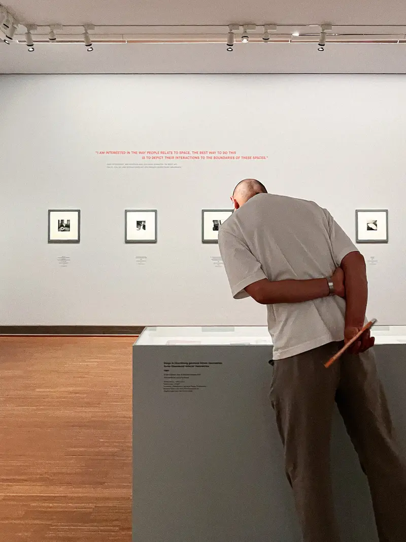 Visitor Examining Framed Artworks at Francesca Woodman Exhibition, Albertina Museum