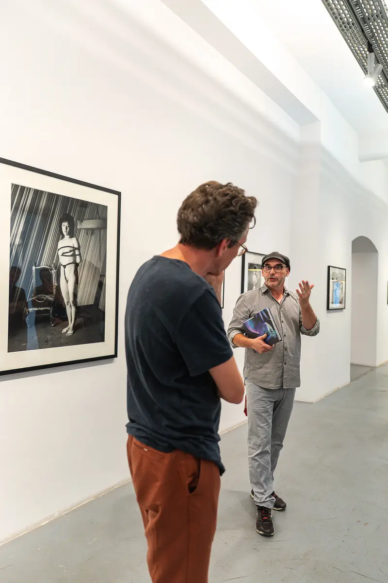 Gallery Visitors Discussing Photographic Exhibition at Ostlicht, Vienna