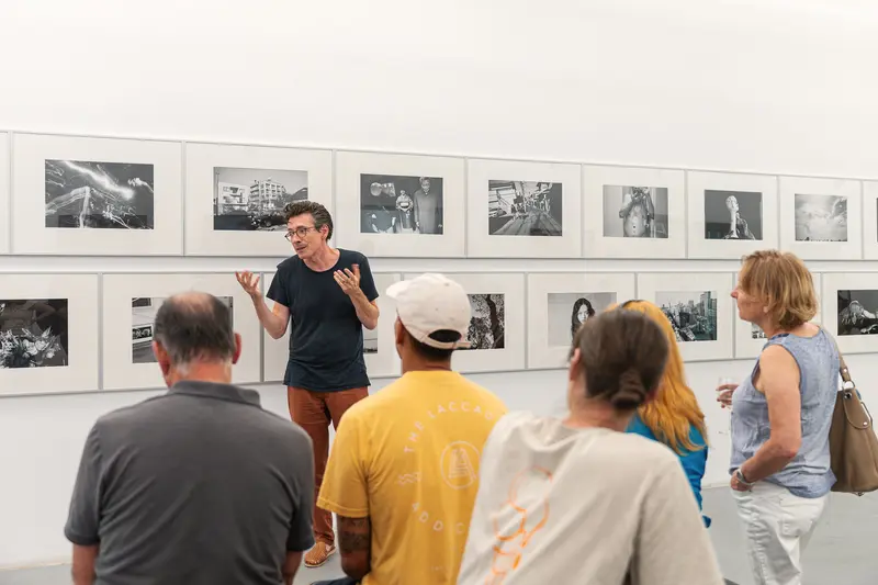 Exhibition Visitors View Black-and-White Photography Series at Ostlicht Gallery