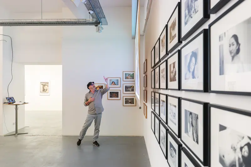 Visitor Examining Portraits at Araki Photography Exhibition at Ostlicht Gallery