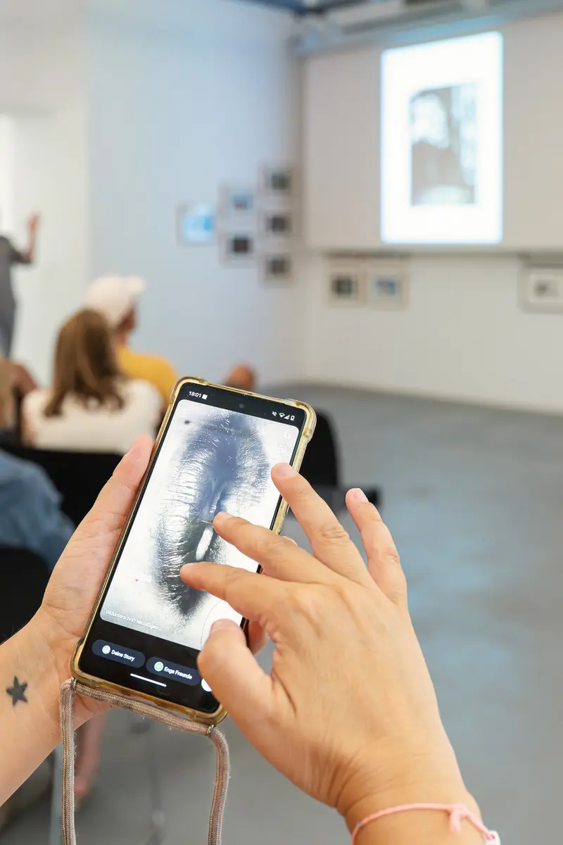 Examining Medical X-Ray on Smartphone During Exhibition at Ostlicht Gallery