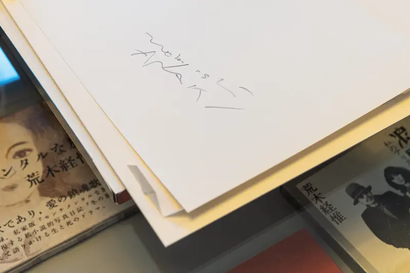 Handwritten Note on White Paper amid Japanese Publications
