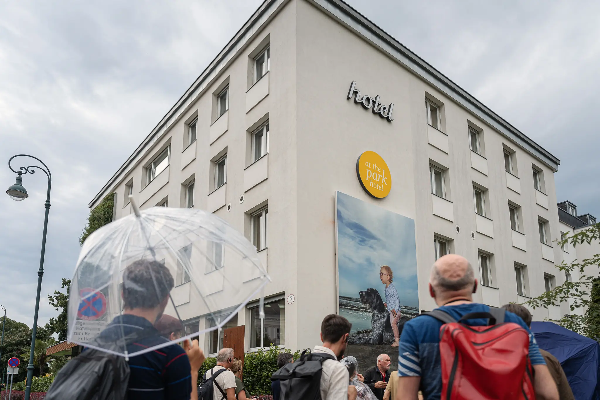 La Gacilly Baden Photography Tour Group Gathering Outside Hostel in Rain