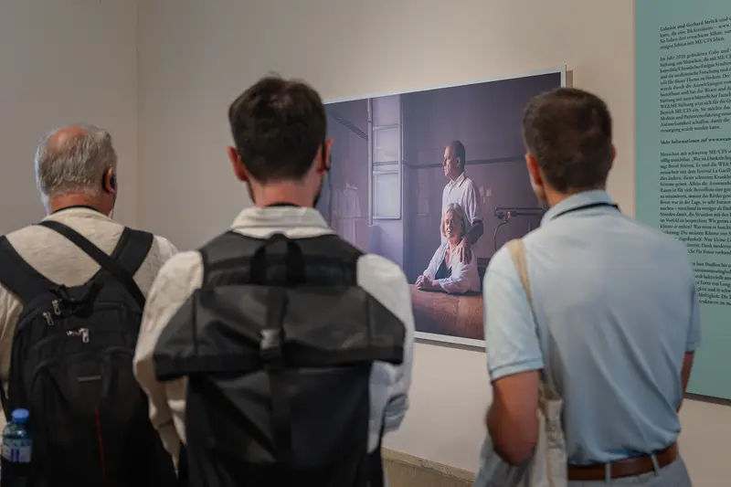 Visitors View Photographic Exhibition at La Gacilly Baden Gallery