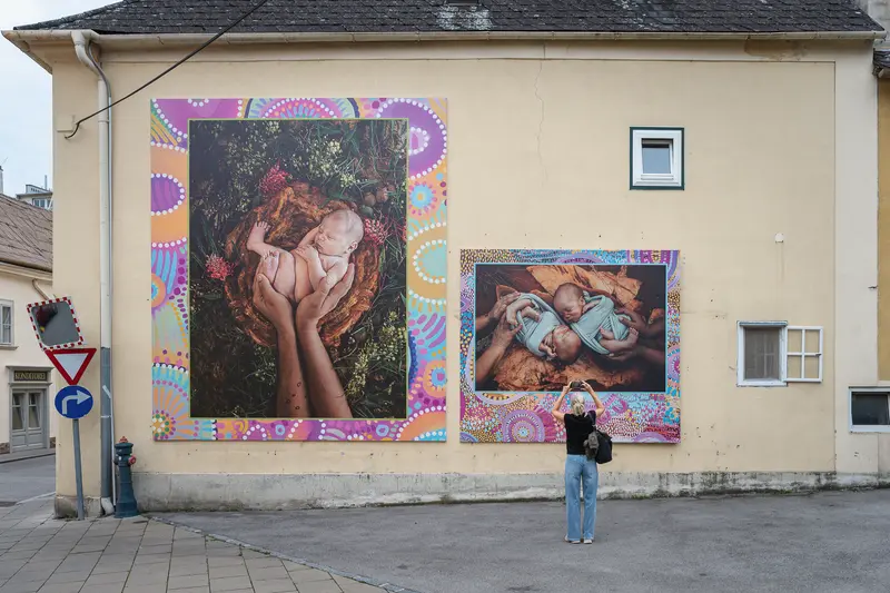 Street Art Murals Depicting Intimate Maternal and Infant Moments in Urban Setting