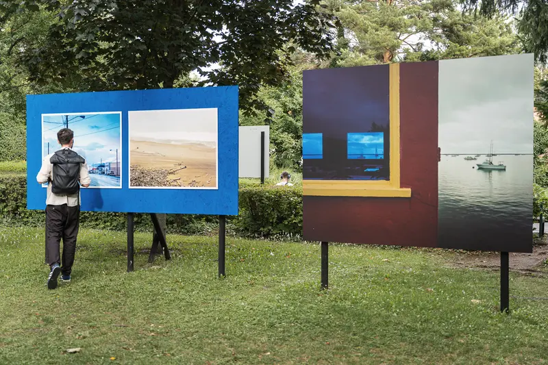 Outdoor Photo Exhibition Displaying Landscape and Seascape Images in Natural Setting