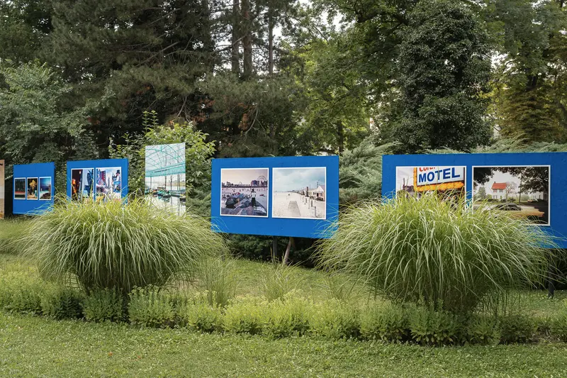 Photographic Exhibition Panels Displaying Motel and Landscape Images in Outdoor Setting