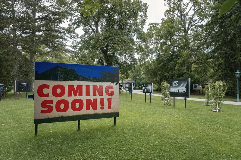 Coming Soon Billboard in Outdoor Park Setting with Multiple Display Boards