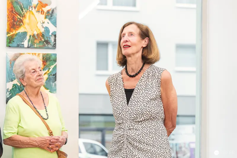 Vernissage "Ladypower" Exhibition: Two Women Amid Colorful Artwork