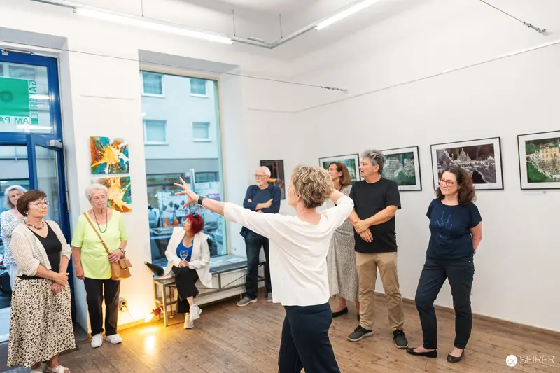 Vernissage "Ladypower" Exhibition: Attendees Discussing Artwork in Gallery Space